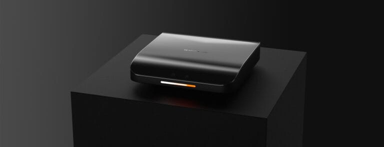 Curved ceramic cooktop development — dark studio shot of the curved glass cooktop on a black display pedestal showing the slim profile